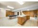 Spacious finished basement with pool table, kitchenette, bookcase, and stairwell at 1828 W 750 S, Trafalgar, IN 46181
