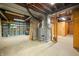 Unfinished basement area with open shelving, mechanicals, and concrete floor at 1828 W 750 S, Trafalgar, IN 46181