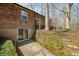 Basement entrance with a sliding glass door and stone retaining walls surrounded by greenery at 1828 W 750 S, Trafalgar, IN 46181