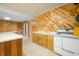 Finished basement includes a kitchenette with wood paneled walls and a view to the backyard at 1828 W 750 S, Trafalgar, IN 46181