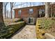 Basement entrance of a brick house with moss-covered retaining walls and a sliding glass door at 1828 W 750 S, Trafalgar, IN 46181