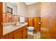 Cozy bathroom features wood paneling, patterned wallpaper, and a classic vanity at 1828 W 750 S, Trafalgar, IN 46181
