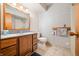 Bathroom with wooden vanity, granite top, mirror, toilet and walk in shower at 1828 W 750 S, Trafalgar, IN 46181