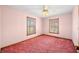 Light-filled bedroom with pink walls, two bright windows, and a ceiling fan, creating a cheerful and inviting personal space at 1828 W 750 S, Trafalgar, IN 46181