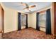 Comfortable bedroom featuring two windows with decorative curtains and a ceiling fan, offering a relaxing and well-lit space at 1828 W 750 S, Trafalgar, IN 46181