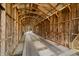 Interior perspective of a wooden covered bridge, showcasing its timber framework and design at 1828 W 750 S, Trafalgar, IN 46181