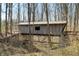 Unique covered bridge feature set among the trees, highlighting the property's natural charm at 1828 W 750 S, Trafalgar, IN 46181