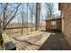 Large wooden deck overlooking a wooded area, attached to a brick house with mature trees at 1828 W 750 S, Trafalgar, IN 46181