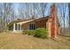 Cozy home featuring a brick facade, screened porch and mature landscaping at 1828 W 750 S, Trafalgar, IN 46181