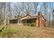 Inviting home with brick and vinyl siding, screened porch, and mature trees at 1828 W 750 S, Trafalgar, IN 46181