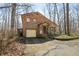 Brick home with a front-facing garage, porch, and mature trees on a sunny day at 1828 W 750 S, Trafalgar, IN 46181