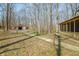 Property featuring a house with porch and an open barn-like structure surrounded by trees at 1828 W 750 S, Trafalgar, IN 46181