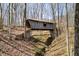Covered bridge surrounded by trees, spanning across a dry creek bed at 1828 W 750 S, Trafalgar, IN 46181