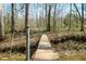 Outdoor foot bridge with metal railings, river, and a wooded area at 1828 W 750 S, Trafalgar, IN 46181