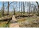 Outdoor foot bridge with metal railings, river, and a wooded area at 1828 W 750 S, Trafalgar, IN 46181