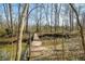 Outdoor foot bridge with metal railings, river, and a wooded area at 1828 W 750 S, Trafalgar, IN 46181