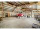 The interior of the outbuilding is open and spacious with a red truck at 1828 W 750 S, Trafalgar, IN 46181