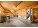 Attached garage with plywood walls, workbench, and access to storage space at 1828 W 750 S, Trafalgar, IN 46181