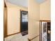A hallway features neutral colored walls, tile floors, and a black door at 1828 W 750 S, Trafalgar, IN 46181