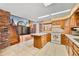 A kitchen with an island sits next to a living room with a wood staircase at 1828 W 750 S, Trafalgar, IN 46181