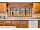 A kitchen sink sits in front of a large window overlooking a wooded view at 1828 W 750 S, Trafalgar, IN 46181