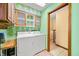 A laundry room features a washer and dryer, tile floors, and a doorway to stairs at 1828 W 750 S, Trafalgar, IN 46181