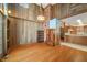 Spacious living room with hardwood floors, brick, a unique light fixture and cabinet at 1828 W 750 S, Trafalgar, IN 46181