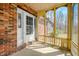 Detailed view of the porch with a white door and brick wall at 1828 W 750 S, Trafalgar, IN 46181