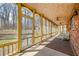 Bright screened porch with ceiling fans and a view of the wooded landscape at 1828 W 750 S, Trafalgar, IN 46181