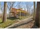 Side exterior view of the home featuring a covered porch and brick siding at 1828 W 750 S, Trafalgar, IN 46181