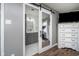 Primary bathroom with sliding barn door, vanity with marble countertops, and modern fixtures at 2109 Elmwood Dr, Lebanon, IN 46052