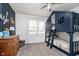 This bedroom features a unique blue-painted bunk bed and neutral carpet at 2109 Elmwood Dr, Lebanon, IN 46052