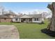 Inviting single story home showcasing a lush front lawn, mature trees, and a welcoming front porch with swing at 2109 Elmwood Dr, Lebanon, IN 46052