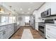 Stunning kitchen featuring stainless steel appliances and gray cabinets, blending style and functionality at 2109 Elmwood Dr, Lebanon, IN 46052