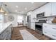 Modern kitchen featuring white cabinets, stainless steel appliances, and stylish gray island with gold accents at 2109 Elmwood Dr, Lebanon, IN 46052