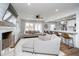Inviting living room featuring plush seating, a ceiling fan, and smooth transition to a modern kitchen at 2109 Elmwood Dr, Lebanon, IN 46052