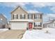 A charming two-story home with a freshly shoveled driveway at 2180 Quarter Path Rd, Cicero, IN 46034