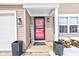 A welcoming entrance with a red door, stylish planters, and a 'Welcome' sign at 2180 Quarter Path Rd, Cicero, IN 46034