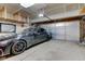 A garage with a shiny black car and a garage door at 2180 Quarter Path Rd, Cicero, IN 46034