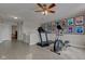Bright home gym features a treadmill, elliptical machine, and wall art at 2180 Quarter Path Rd, Cicero, IN 46034