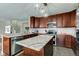 Kitchen with a granite island, stainless steel appliances, and wood cabinets at 2180 Quarter Path Rd, Cicero, IN 46034