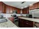 Kitchen with stainless steel appliances, granite countertops, wood cabinets, and a kitchen island at 2180 Quarter Path Rd, Cicero, IN 46034