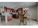 A spacious eat-in kitchen with wood cabinets, an island, pendant lights, and stainless steel appliances at 2180 Quarter Path Rd, Cicero, IN 46034