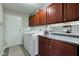 Laundry room with countertop space, overhead cabinets, and a front-loading washer and dryer at 2180 Quarter Path Rd, Cicero, IN 46034