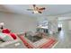 Cozy living room with a plush sofa, decorative rug, and a view of the staircase at 2180 Quarter Path Rd, Cicero, IN 46034