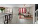 Open living room with modern decor, a cozy sofa, and a view of the dining area at 2180 Quarter Path Rd, Cicero, IN 46034