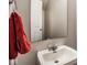 A simple bathroom featuring a white sink and a red towel for use at 2357 Central Ave, Indianapolis, IN 46205