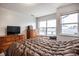 A well-lit bedroom with neutral tones and a large window for natural light at 2357 Central Ave, Indianapolis, IN 46205