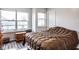 A comfortable bedroom features a cozy quilt and natural light from windows at 2357 Central Ave, Indianapolis, IN 46205