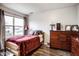 Cozy bedroom with wood floors features natural light and a wood dresser against the wall at 2357 Central Ave, Indianapolis, IN 46205
